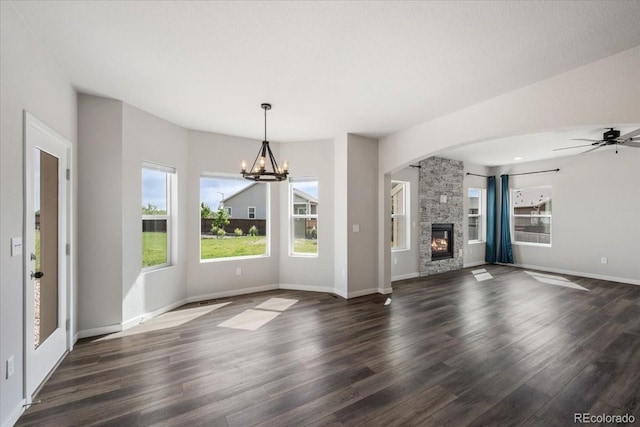 1711 Lazear St, Loveland, CO 80538 - unfurnished living room with dark wood-type flooring, a chandelier, a fireplace, baseboards, and ceiling fan