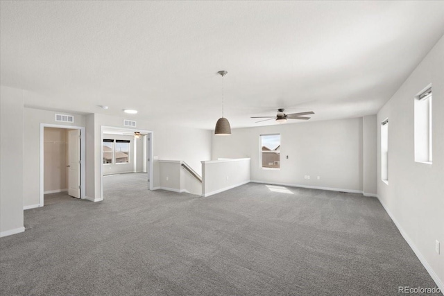 1711 Lazear St, Loveland, CO 80538 - unfurnished living room featuring ceiling fan, carpet floors, and plenty of natural light