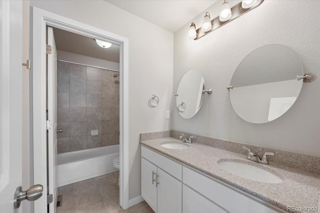 1711 Lazear St, Loveland, CO 80538 - full bath featuring double vanity, tile patterned flooring, toilet, and shower / bath combination