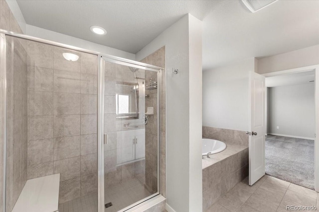 1711 Lazear St, Loveland, CO 80538 - bathroom with a garden tub, tile patterned floors, a stall shower, and recessed lighting