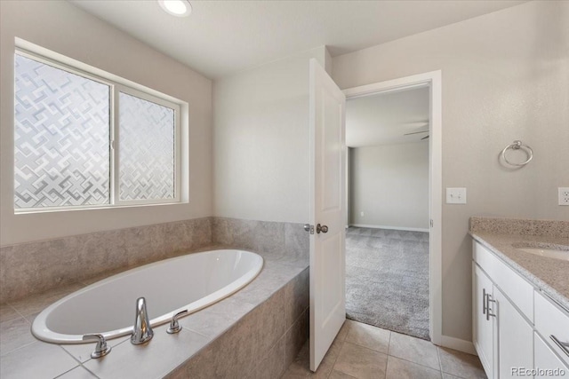 1711 Lazear St, Loveland, CO 80538 - full bathroom with vanity, a garden tub, tile patterned floors, and baseboards