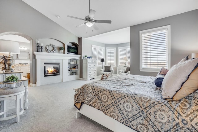 bedroom featuring ceiling fan, vaulted ceiling, and light carpet