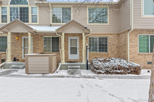 view of snow covered property entrance