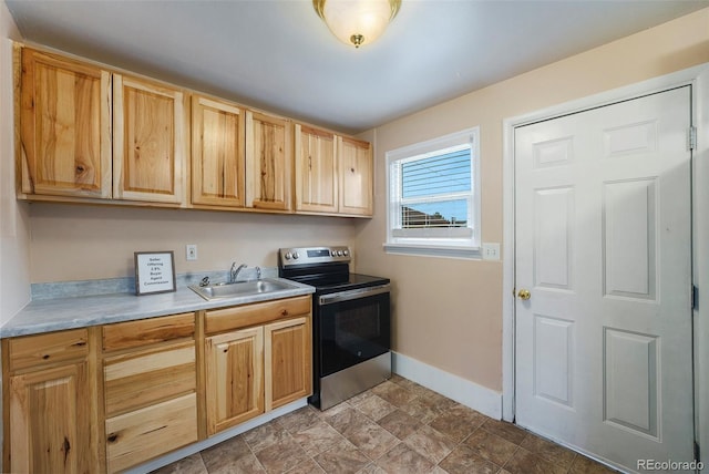 1200 Newark St, Aurora, CO 80010 - kitchen featuring stainless steel range with electric stovetop, light countertops, light brown cabinets, and stone finish flooring