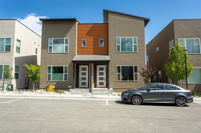 view of front of home featuring metal roof and stucco siding