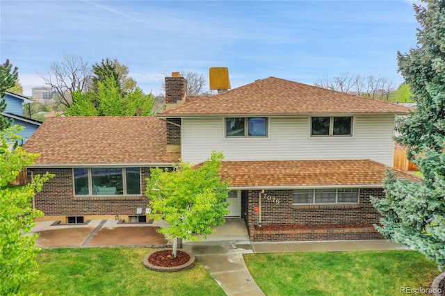 7076 S Spruce Dr W, Centennial, CO 80112 - view of front of home featuring a chimney, a patio, a front yard, roof with shingles, and brick siding