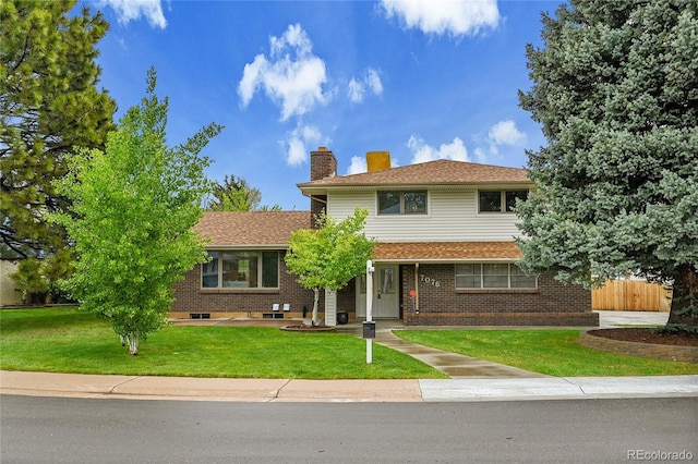 7076 S Spruce Dr W, Centennial, CO 80112 - view of front of home featuring a chimney and brick siding