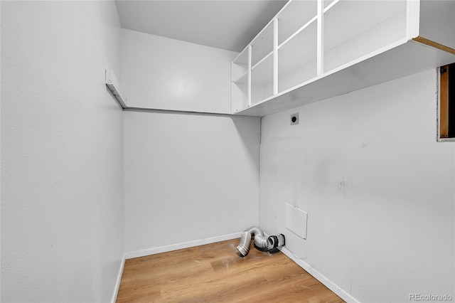 7076 S Spruce Dr W, Centennial, CO 80112 - washroom featuring electric dryer hookup, wood finished floors, and baseboards