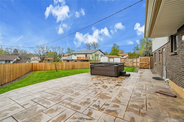 7076 S Spruce Dr W, Centennial, CO 80112 - view of patio featuring a hot tub, a residential view, and a gate