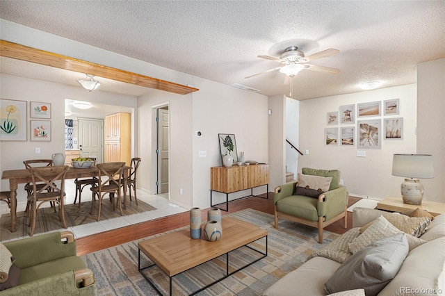 3593 S Kittredge St Unit E, Aurora, CO 80013 - living room with a textured ceiling, light wood-type flooring, a ceiling fan, and stairway