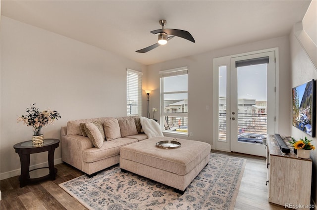 living room featuring wood-type flooring and ceiling fan