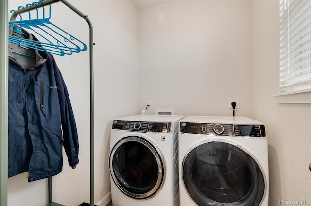 washroom featuring washing machine and dryer