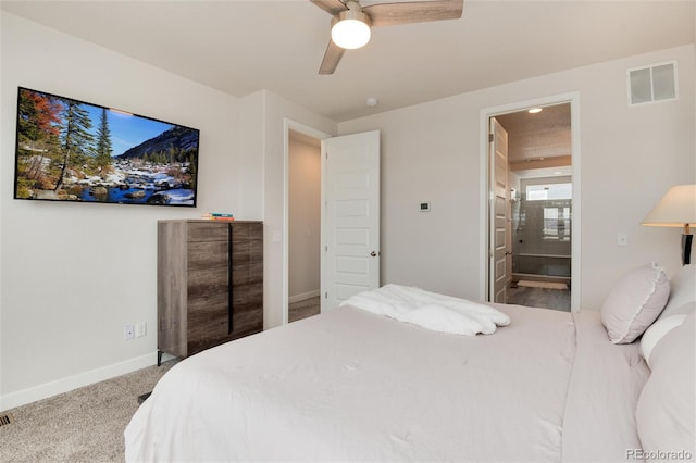 bedroom featuring ceiling fan, light colored carpet, and ensuite bathroom