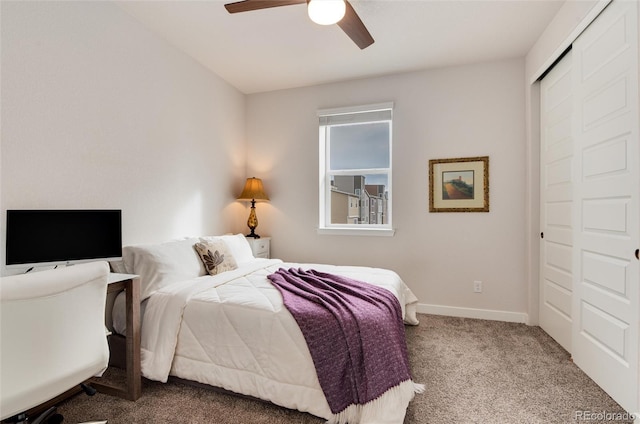 carpeted bedroom featuring a closet and ceiling fan