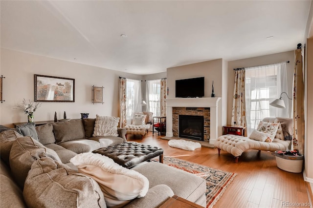 living room featuring wood finished floors and a fireplace