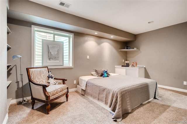 bedroom with baseboards, visible vents, and light carpet