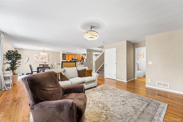 2695 E 109th Ave, Northglenn, CO 80233 - living room with light wood-style flooring and stairway