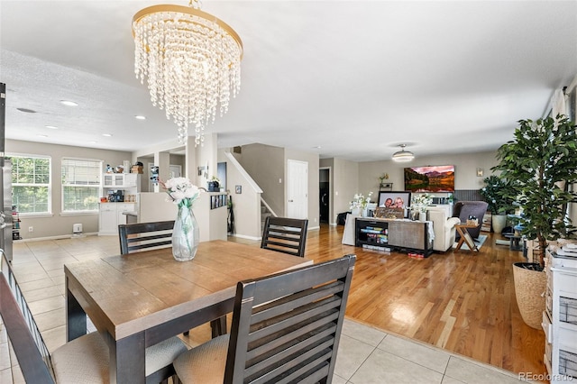 2695 E 109th Ave, Northglenn, CO 80233 - dining space featuring a chandelier, light tile patterned floors, stairs, and recessed lighting