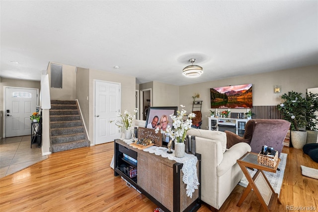 2695 E 109th Ave, Northglenn, CO 80233 - living room featuring stairway and light wood-type flooring