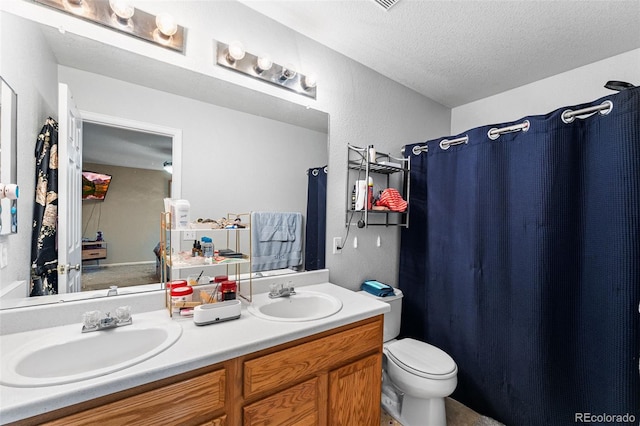 2695 E 109th Ave, Northglenn, CO 80233 - bathroom featuring double vanity, a textured ceiling, and a shower with curtain