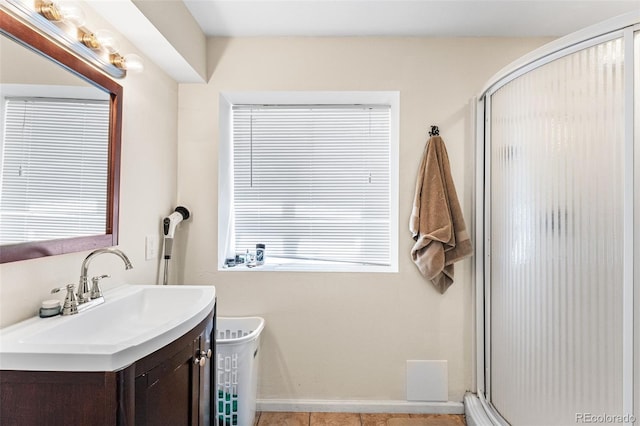 2695 E 109th Ave, Northglenn, CO 80233 - full bathroom featuring a stall shower, vanity, and tile patterned flooring