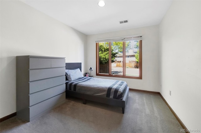 carpeted bedroom with baseboards