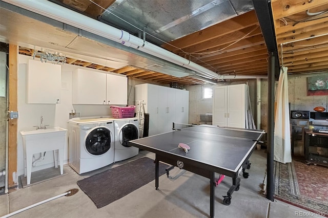rec room with separate washer and dryer and concrete flooring