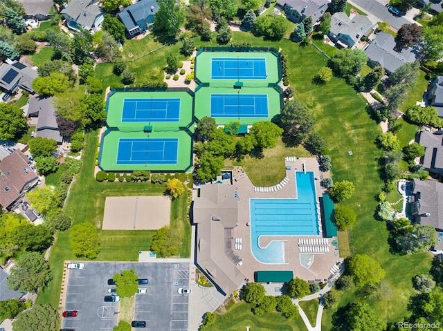 aerial overview of property's location with a pool area and nearby suburban area