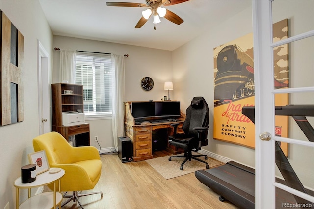 office area with baseboards, a ceiling fan, and wood finished floors