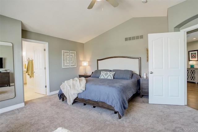 carpeted bedroom featuring ceiling fan, baseboards, ensuite bathroom, lofted ceiling, and visible vents