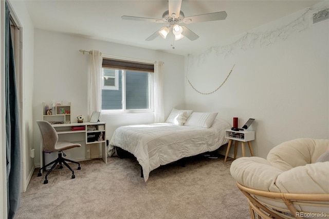 bedroom featuring visible vents, a ceiling fan, and light colored carpet