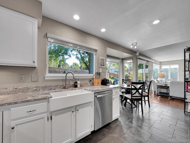 1052 Northampton Ct, Highlands Ranch, CO 80126 - kitchen featuring dishwasher, white cabinetry, a textured ceiling, light stone counters, and recessed lighting