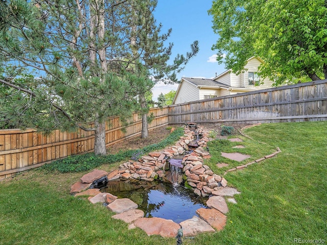 1052 Northampton Ct, Highlands Ranch, CO 80126 - fenced backyard featuring a small pond