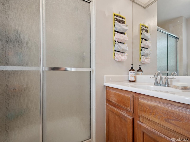 bathroom featuring a shower stall and vanity