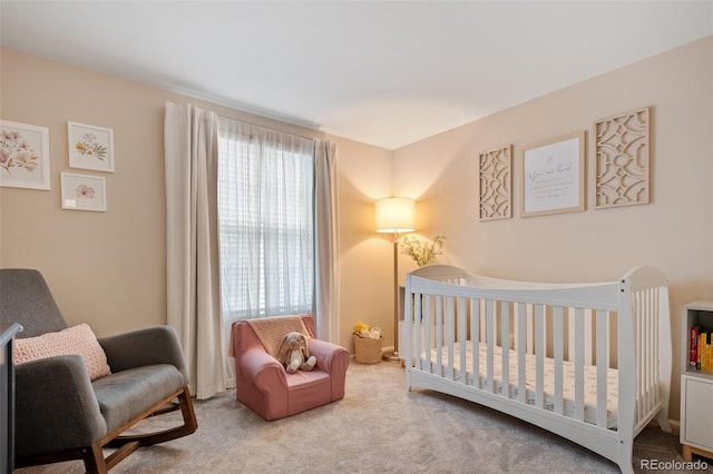 carpeted bedroom with a nursery area