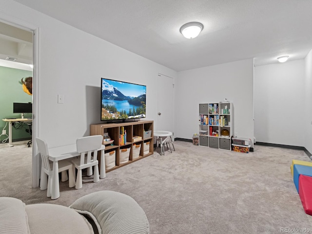 playroom with baseboards, visible vents, and carpet flooring