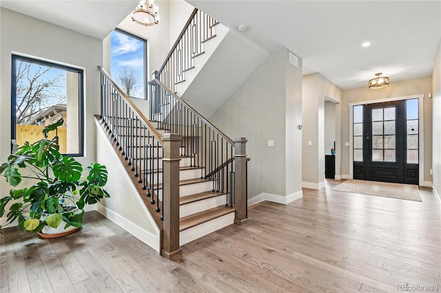 entrance foyer featuring recessed lighting, stairway, baseboards, and wood finished floors
