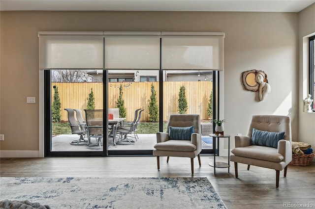 sitting room featuring baseboards and wood finished floors