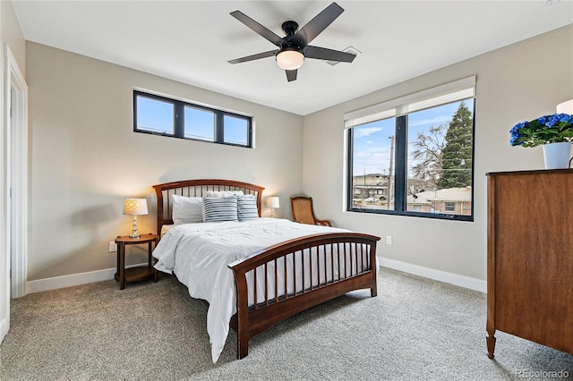 bedroom with multiple windows, carpet flooring, and baseboards