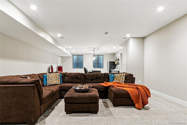 carpeted living area with visible vents, recessed lighting, and baseboards