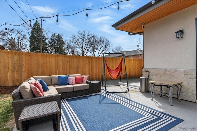view of patio / terrace featuring outdoor lounge area and fence
