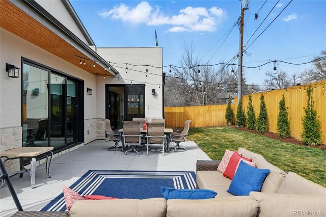 view of patio / terrace featuring outdoor dining space, outdoor lounge area, and a fenced backyard