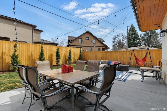 view of patio with outdoor dining space, an outdoor hangout area, and a fenced backyard