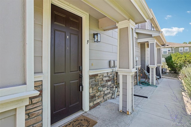 17145 Waterhouse Cir Unit F, Parker, CO 80134 - doorway to property featuring stone siding and a porch
