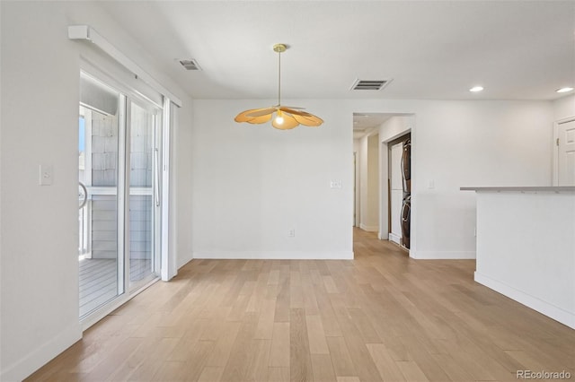 17145 Waterhouse Cir Unit F, Parker, CO 80134 - spare room featuring stacked washer / dryer, light wood-style floors, ceiling fan, recessed lighting, and plenty of natural light