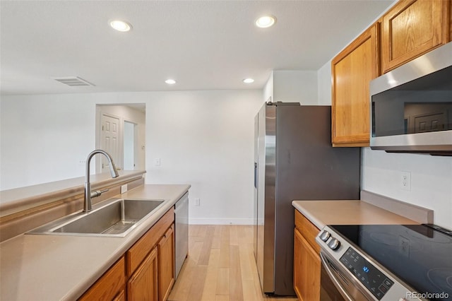 17145 Waterhouse Cir Unit F, Parker, CO 80134 - kitchen featuring stainless steel appliances, light wood finished floors, brown cabinets, recessed lighting, and light countertops