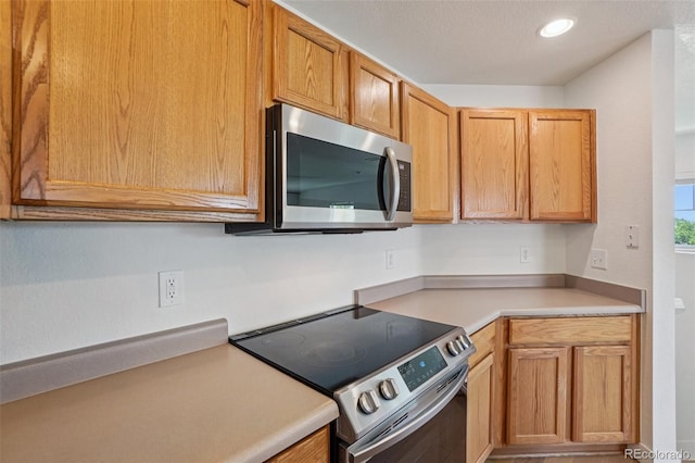 17145 Waterhouse Cir Unit F, Parker, CO 80134 - kitchen with appliances with stainless steel finishes, light countertops, and recessed lighting