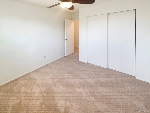 unfurnished bedroom featuring a closet, ceiling fan, baseboards, and carpet