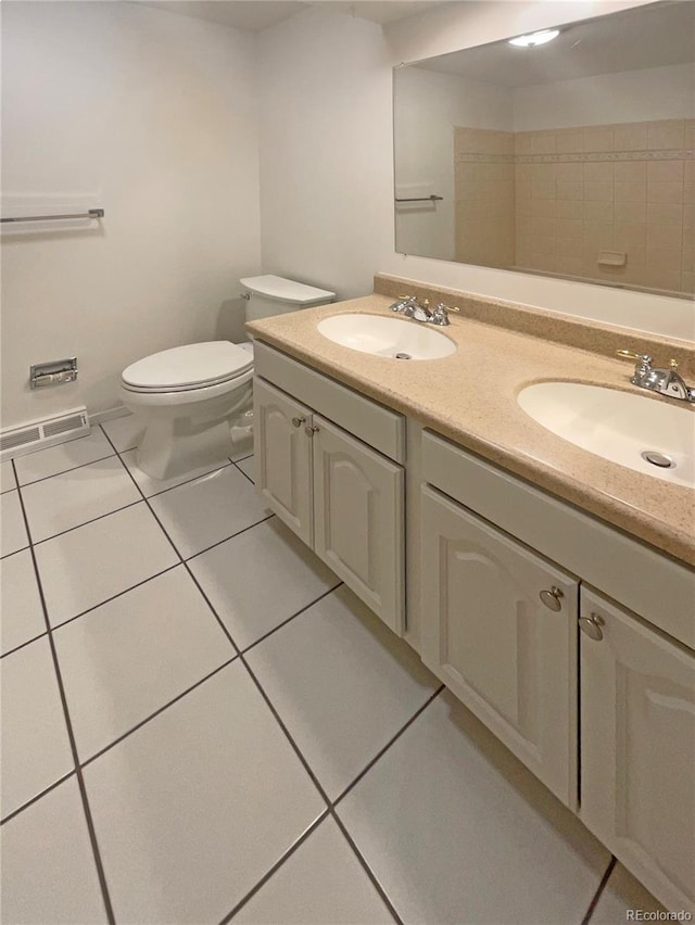 full bathroom with a sink, toilet, double vanity, and tile patterned flooring