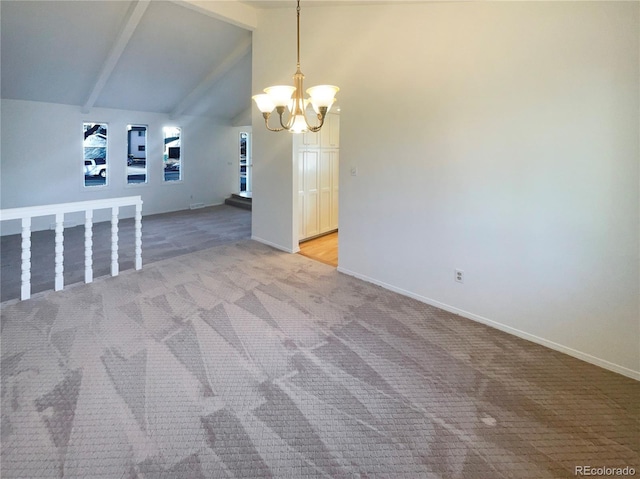 spare room featuring baseboards, beamed ceiling, light carpet, and an inviting chandelier